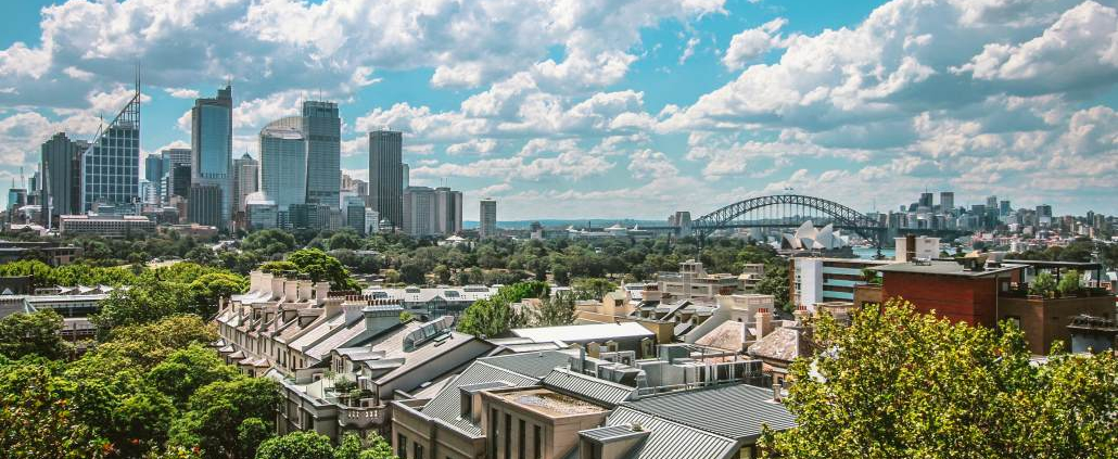 A view over a suburb of Sydney, Australia, with downtown Sydney, Sydney Opera House and Sydney Harbour Bridge in the background