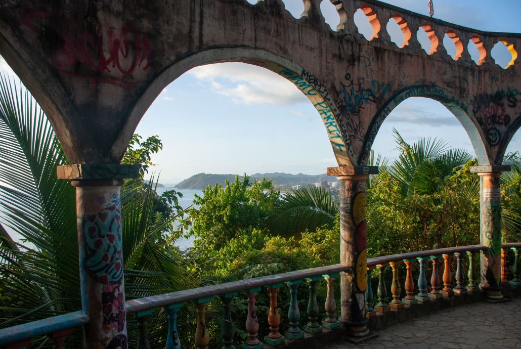 A painted archway on a balcony overlooking the coast in Costa Rica