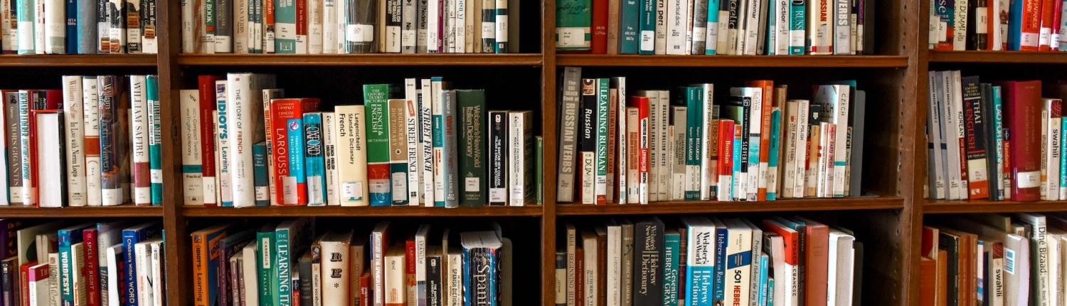 Rows of assorted books on shelves in a library