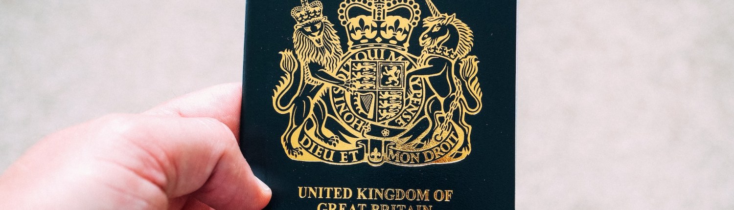 A close-up of a hand holding a British passport